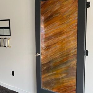 A custom copper door with black trim